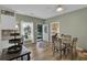 A dining area features wood floors, a granite topped table, and access to the outdoors at 530 Chicapoo Dr, Marietta, GA 30066
