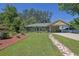 Beautifully landscaped front yard with lush green grass and a stone pathway leading to the charming home at 530 Chicapoo Dr, Marietta, GA 30066