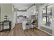 Bright kitchen with white cabinets, stainless steel appliances, and a breakfast bar with seating at 530 Chicapoo Dr, Marietta, GA 30066