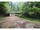 Quaint one-story home nestled among lush trees with a covered carport and driveway at 1847 Colt Dr, Brookhaven, GA 30341