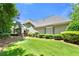 Landscaped backyard featuring a well-maintained lawn, mature trees, and the home's exterior at 2001 Macland Square Dr # 11, Marietta, GA 30064