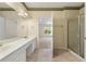 Bathroom featuring double sinks, a shower with glass doors, and an open doorway to the bedroom at 2001 Macland Square Dr # 11, Marietta, GA 30064