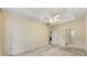 Bedroom with neutral walls and carpet featuring a ceiling fan, multiple doorways, and tray ceiling at 2001 Macland Square Dr # 11, Marietta, GA 30064