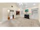 Open-concept living room featuring a fireplace with built-ins and hardwood flooring, showcasing kitchen access at 2001 Macland Square Dr # 11, Marietta, GA 30064
