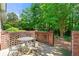 Outdoor patio with seating area surrounded by a decorative brick wall and lush green foliage at 2001 Macland Square Dr # 11, Marietta, GA 30064