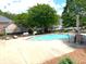 Community swimming pool surrounded by lounge chairs and lush landscaping at 2001 Macland Square Dr # 11, Marietta, GA 30064