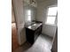 Bathroom vanity showcasing granite countertop with dark wood cabinets and tile floor at 2363 Bear Mountain St, Lithonia, GA 30058