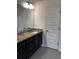 Bathroom with double vanity, granite countertop, and chrome fixtures at 2363 Bear Mountain St, Lithonia, GA 30058