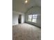 Bedroom featuring a vaulted ceiling, carpet, and a large window overlooking the yard at 2363 Bear Mountain St, Lithonia, GA 30058
