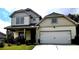 Charming two-story home with an attached two-car garage and well-maintained front yard at 2363 Bear Mountain St, Lithonia, GA 30058