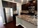 Kitchen boasts dark wood cabinets, stainless steel appliances, and granite countertops at 2363 Bear Mountain St, Lithonia, GA 30058