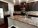Beautiful kitchen island with granite countertops, stainless steel sink and dark cabinets at 2363 Bear Mountain St, Lithonia, GA 30058