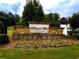 Stone entrance sign for Mason's Mill Estates with landscaping and colorful flowers at 2363 Bear Mountain St, Lithonia, GA 30058