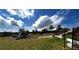 Community playground with slides, green grass, and shade trees for outdoor fun at 2363 Bear Mountain St, Lithonia, GA 30058