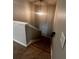 A view down the carpeted staircase with modern hanging light fixture at 2363 Bear Mountain St, Lithonia, GA 30058