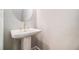 Elegant powder room features a pedestal sink and modern fixtures at 2406 Lakeshore Ln, Atlanta, GA 30316