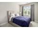 Cozy bedroom featuring a comfortable bed with a blue duvet and a bright window view at 2406 Lakeshore Ln, Atlanta, GA 30316