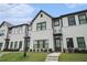 Inviting townhome featuring light brickwork, dark window frames, and professional landscaping at 2406 Lakeshore Ln, Atlanta, GA 30316