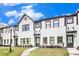 Elegant townhome exteriors with white brick, black accents, and neat landscaping at 2406 Lakeshore Ln, Atlanta, GA 30316