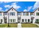 Charming townhomes featuring white brick, black trim, and well-manicured lawns under a bright sky at 2406 Lakeshore Ln, Atlanta, GA 30316