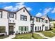 Beautiful exterior featuring white brick, dark trim, sidewalk, and well manicured front lawn at 2406 Lakeshore Ln, Atlanta, GA 30316