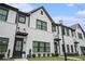 Beautiful townhome highlighting white brick, black trim, and a well-maintained front lawn at 2406 Lakeshore Ln, Atlanta, GA 30316