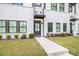 Close-up of a townhouse exterior with brick facade, dark trim, and a well-kept lawn at 2406 Lakeshore Ln, Atlanta, GA 30316