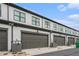 Attached garages showing gray doors, light siding, and dark trim at 2406 Lakeshore Ln, Atlanta, GA 30316