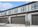 Attached garages with gray doors, white siding, and black trim at 2406 Lakeshore Ln, Atlanta, GA 30316