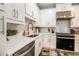 Close-up of a well-lit kitchen with white cabinets and stainless steel appliances at 2406 Lakeshore Ln, Atlanta, GA 30316