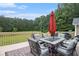 Backyard deck with outdoor seating, a fire pit table, and view of surrounding trees at 4746 Mulberry Rock Rd, Dallas, GA 30157