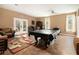 Basement features a pool table, an eclectic rug, and access to the backyard at 4746 Mulberry Rock Rd, Dallas, GA 30157