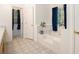 Bright bathroom featuring a large soaking tub, blue curtains, and a tiled floor at 4746 Mulberry Rock Rd, Dallas, GA 30157