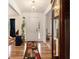 Inviting entryway with hardwood floors, white walls, and plant accents leading into the rest of the home at 4746 Mulberry Rock Rd, Dallas, GA 30157