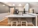 Charming kitchen features a breakfast bar with seating, stylish countertops, and stainless steel refrigerator at 4746 Mulberry Rock Rd, Dallas, GA 30157