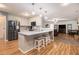 Bright kitchen boasts an island with seating, stainless appliances, and flows into the living area at 4746 Mulberry Rock Rd, Dallas, GA 30157