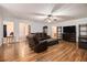 Cozy living room with hardwood floors features a large sectional sofa and media center at 4746 Mulberry Rock Rd, Dallas, GA 30157