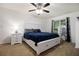 Airy bedroom features a fan, a bright window, a bed with drawers, and two dressers at 4746 Mulberry Rock Rd, Dallas, GA 30157