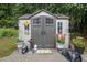 Exterior view of the backyard storage shed, surrounded by potted plants and garden accents at 4746 Mulberry Rock Rd, Dallas, GA 30157
