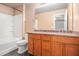 Bathroom with double vanity, wood cabinets, and tub with shower at 1684 Tailmore Ln, Lawrenceville, GA 30043