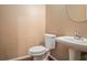 Cozy half bathroom features a modern pedestal sink and sleek fixtures at 1684 Tailmore Ln, Lawrenceville, GA 30043