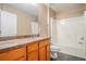 Bathroom featuring a single vanity, granite countertops, and tiled shower at 1684 Tailmore Ln, Lawrenceville, GA 30043