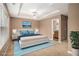 Spacious main bedroom with tray ceiling, ceiling fan, and ensuite bathroom at 1684 Tailmore Ln, Lawrenceville, GA 30043