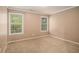 Inviting carpeted bedroom with two windows and neutral paint at 1684 Tailmore Ln, Lawrenceville, GA 30043