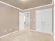 Carpeted bedroom with closets and a view to another room at 1684 Tailmore Ln, Lawrenceville, GA 30043