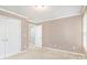Carpeted bedroom featuring neutral paint, a ceiling light and closet doors at 1684 Tailmore Ln, Lawrenceville, GA 30043