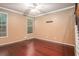 Spacious bedroom featuring hardwood floors, neutral paint, and bright natural light at 1684 Tailmore Ln, Lawrenceville, GA 30043