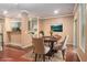 Formal staged dining room adjacent to kitchen, features elegant table and chairs at 1684 Tailmore Ln, Lawrenceville, GA 30043