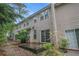 Exterior rear view of home with siding and a sliding glass door leading to patio at 1684 Tailmore Ln, Lawrenceville, GA 30043