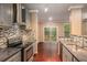 Modern kitchen with granite countertops, stainless steel appliances, and stylish backsplash at 1684 Tailmore Ln, Lawrenceville, GA 30043